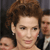 A pixelated close-up of a person with curly brown hair, light skin, and a neutral expression, partially cropped on the left and right edges.