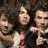 Animated sequence of a group of young men in various poses, including pointing gestures and hand-over-eyes actions.