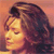 Static pixelated image of a person's face with long dark hair against an orange background, rendered in low-resolution style typical of early internet buddy icons.