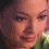 A four- shows a person's face with subtle expression changes , featuring light skin, dark hair, and green clothing against a dark background