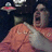 A pixelated image of a person in an orange outfit with a white sash, holding a microphone against a dark background with a small UFO graphic.