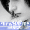 Black-and-white close-up of a person's face with closed eyes, dark hair, and a blue banner displaying pixelated text at the bottom.