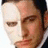 Pixelated close-up of a person's face showing partial features including eyes, nose, and mouth with visible pixelation and color blending.