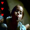 A static image shows a child with light brown hair wearing a blue and white patterned shirt, with three red heart symbols aligned vertically on the left side.