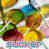 Colorful circular candies with white lines on a pattern, each displaying the word 'sucker' in blue text below