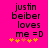 A bright pink background displays black pixelated text reading "justin beiber loves me =D" with yellow and orange star-like symbols below, showing animation changes in the bottom
