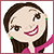 Pixelated cartoon-style icon of a person with brown hair, green earrings, and pink clothing smiling broadly.