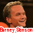 Pixelated image of a smiling man with light brown hair, overlaid with red text fragments on dark and gray backgrounds.