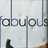 Pixelated static image showing partial text 'obous' in dark gray letters on light gray background with vertical blue lines.