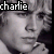 Pixelated grayscale image of a person's face with the word 'charlie' in white text on black background at top left.