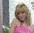 Pixelated static image of a person with light brown hair wearing pink clothing against a checkered background.