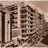 Pixelated static image of a building facade with multiple windows and architectural details in brown and beige tones.