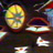 Pixelated static image of a yellow planet with green bands and a red ring system against a dark background with scattered light spots.