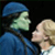 Animated image with green background showing two figures and pixelated text elements.