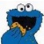 Blue cartoon character with large white eyes and black pupils, open mouth showing yellow teeth-like shapes against dark interior.