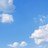 Static image of a blue sky with scattered white clouds, no visible text or figures.