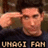 Pixelated image of a person saluting with right hand, wearing dark shirt, against blurred background with text "URAGI FAN" at bottom.