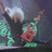 Pixelated image of a figure with light hair holding a red guitar-like instrument against a dark background.