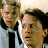 Static 48x48 pixel icon showing two male characters in formal attire with a light background, rendered at low resolution with visible dithering and color blending.