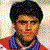 24 individual headshots arranged in four and six , each showing a person with dark hair wearing red-and-blue striped sports jerseys against varied backgrounds