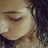 Pixelated close-up of a person's face with closed eyes, dark hair on the right side, and light skin tones against a muted background.