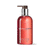 A static image of a red pump bottle with a metallic silver and dark brown pump top against a white background.