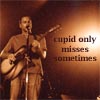 A person in brown clothing plays an acoustic guitar while singing into a microphone, with text reading 'cupid only misses sometimes' on the right side.
