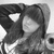 A grayscale animated icon shows a person with long hair and a hooded garment, smiling while adjusting their hood in