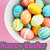 A bowl of colorful Easter eggs on a pink background with 'Happy Easter' text in varying colors.