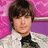 Pixelated portrait of a person with brown hair wearing a white jacket over a black shirt against a pink and purple background.