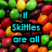 Pixelated image of colorful candy-coated chocolates with cyan text overlay asking about missing blue Skittles.