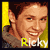 Pixelated portrait of a person with brown hair and light skin, wearing a gray hoodie against a yellow background with the name 'Ricky' in white text.