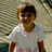 A child in a white shirt with pink trim stands against a striped background, displaying text changes across frames.