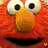 A pixelated close-up of a red, fuzzy character with large white eyes and an orange nose, showing no visible motion.