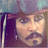 Pixelated image of a person with dark hair and mustache, wearing a hat, next to pixelated text reading 'Real Men Wear Eyeliner' on black background.