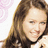 Pixelated image of a smiling woman with long brown hair on left, bright blue background with pink text "WOOHOO!!" and "Miley SEXY!!!! Cyrus".