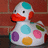 Pixelated cartoon duck with white body, red beak, black eyes, and multicolored circular spots on its chest against a red brick background.