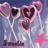 Heart-shaped lollipops with pink borders and dark centers on white sticks against a blue background with a pink star and 'Sweetie' text.