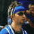 Pixelated static image of a person with blue headband and light blue outfit against dark background, likely from early 2000s digital art style.