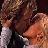 Two figures in close physical proximity with one figure's face near the other's shoulder, rendered in low-resolution pixelated style.