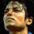 A four- of pixelated images showing a person in various poses and expressions, including a close-up, a smiling face, and a full-body stage performance