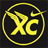 Yellow pixelated 'XC' letters inside a broken circular border on black background, with arrow-like extension from top-right of circle.