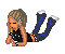 Pixelated female figure in black top and blue pants lies prone on gray background, legs bent upward with white-tipped footwear.