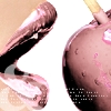 A close-up of a person's mouth with lips parted, showing teeth and tongue, next to a hand holding a cigarette near a face with pink marks.