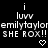 Pixelated text and symbols on black background: two 'i' characters above 'lUVV', repeated names, 'SHE ROX!!', and heart shapes.