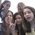 Group of five people in a selfie pose with one person making a peace sign, displayed across four showing slight variations