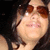 A person with dark hair and brown sunglasses appears in a of four , showing slight variations in head position and facial expression