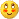 Pixelated yellow circular emoji face with brown eyes, white pupils, orange blush marks, and a small dark brown mouth on gray background.