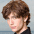 Pixelated image of a person with brown hair and black clothing, displayed in two showing different head angles