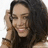 A pixelated image of a person with long dark hair holding a phone to their ear, next to a black background with white text reading "vanessa's hot".